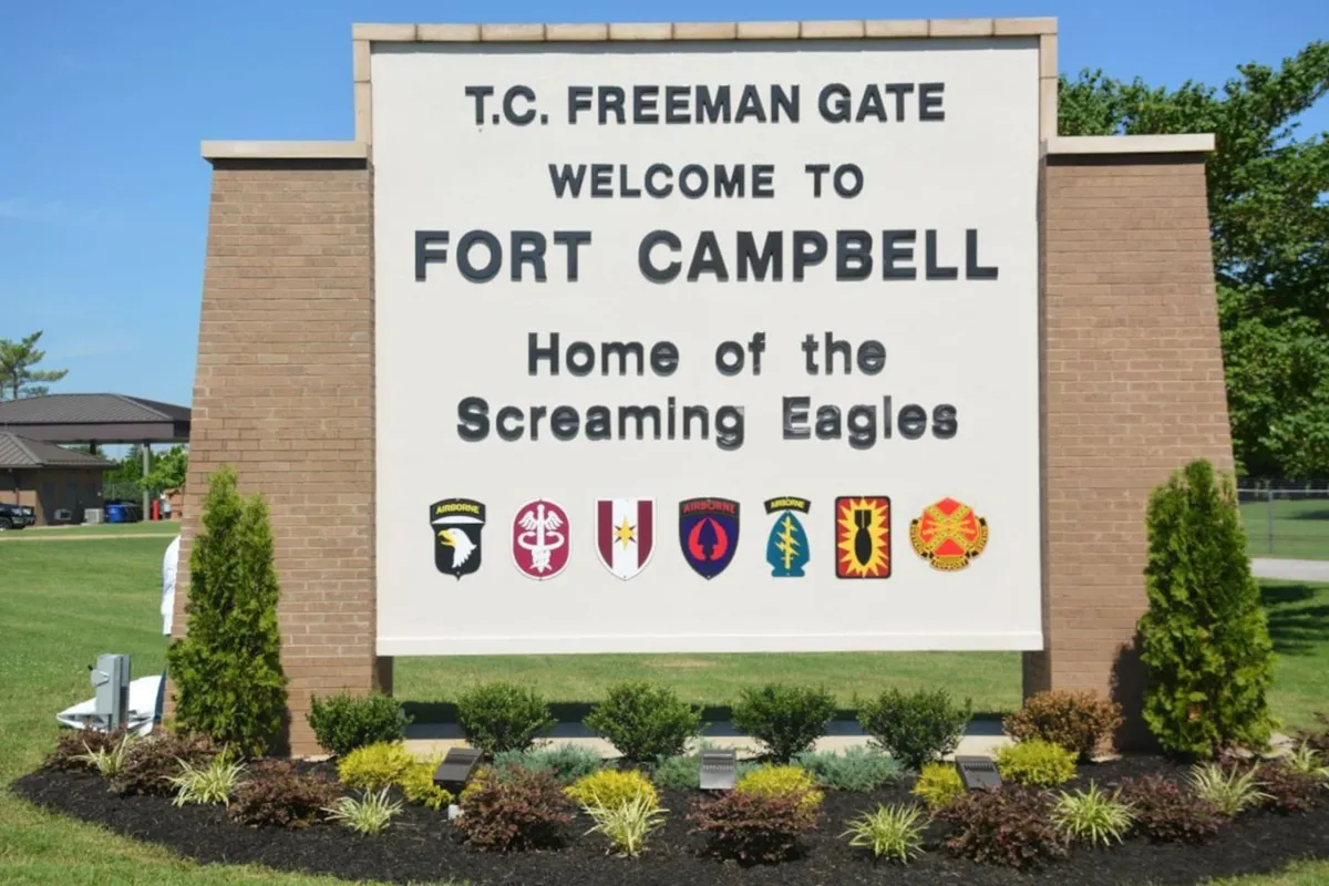 This image shows the recognizable Fort Campbell sign, adorned with military insignias and surrounded by well-maintained landscaping. The sign serves as a landmark for the base, evoking a sense of history, service, and community pride.